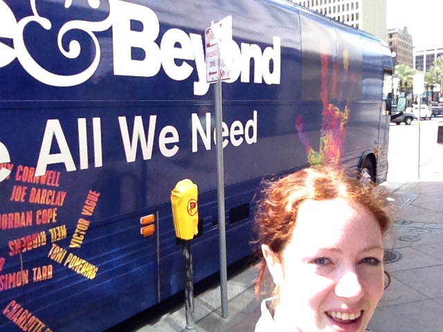 Lizzy taking a selfie with Above and Beyond's bus.