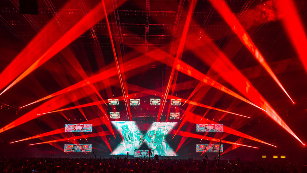 Excision bathes the crowd in red lazers at the Thunderdome tour in Tacoma, WA in 2020