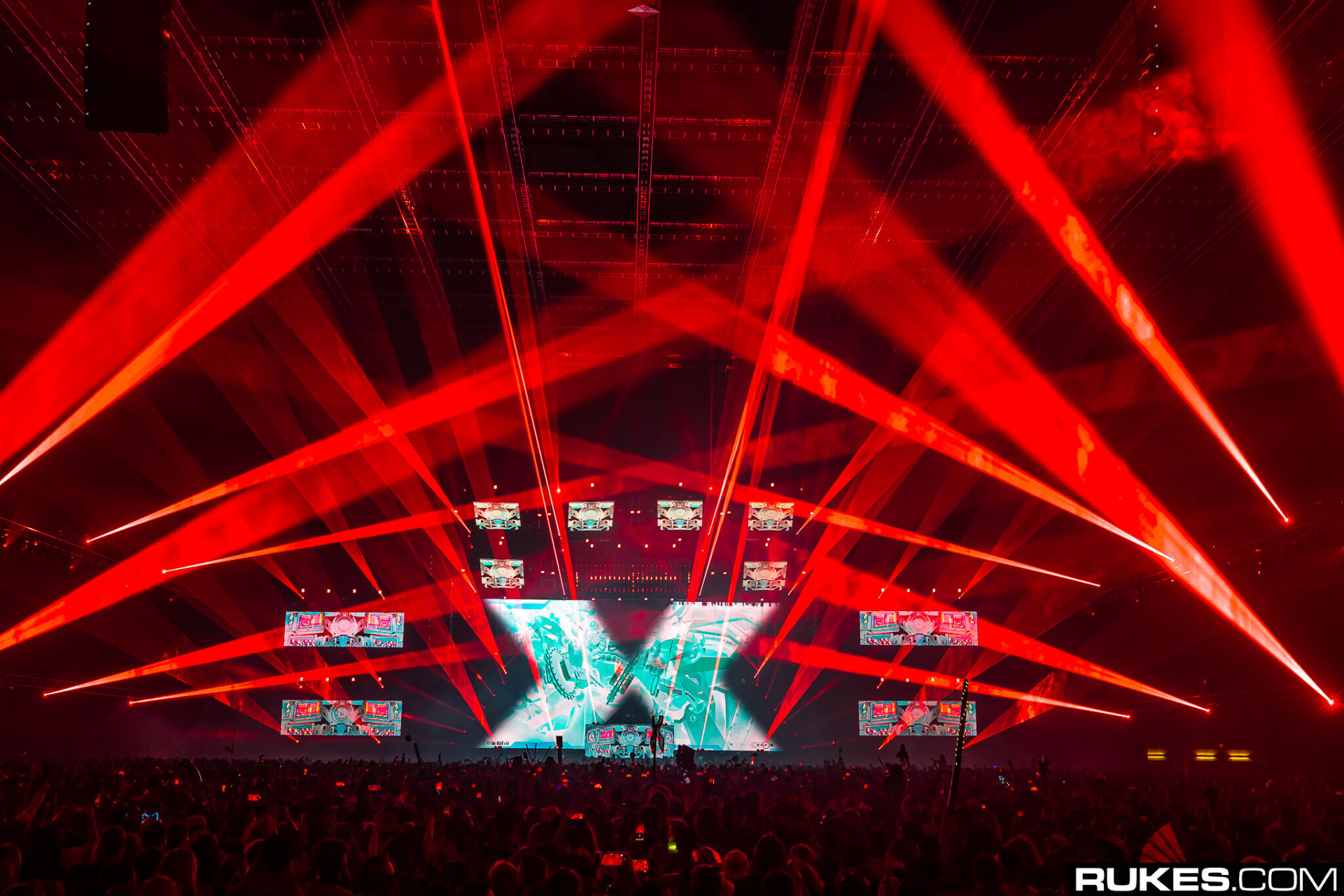 Excision bathes the crowd in red lazers at the Thunderdome tour in Tacoma, WA in 2020