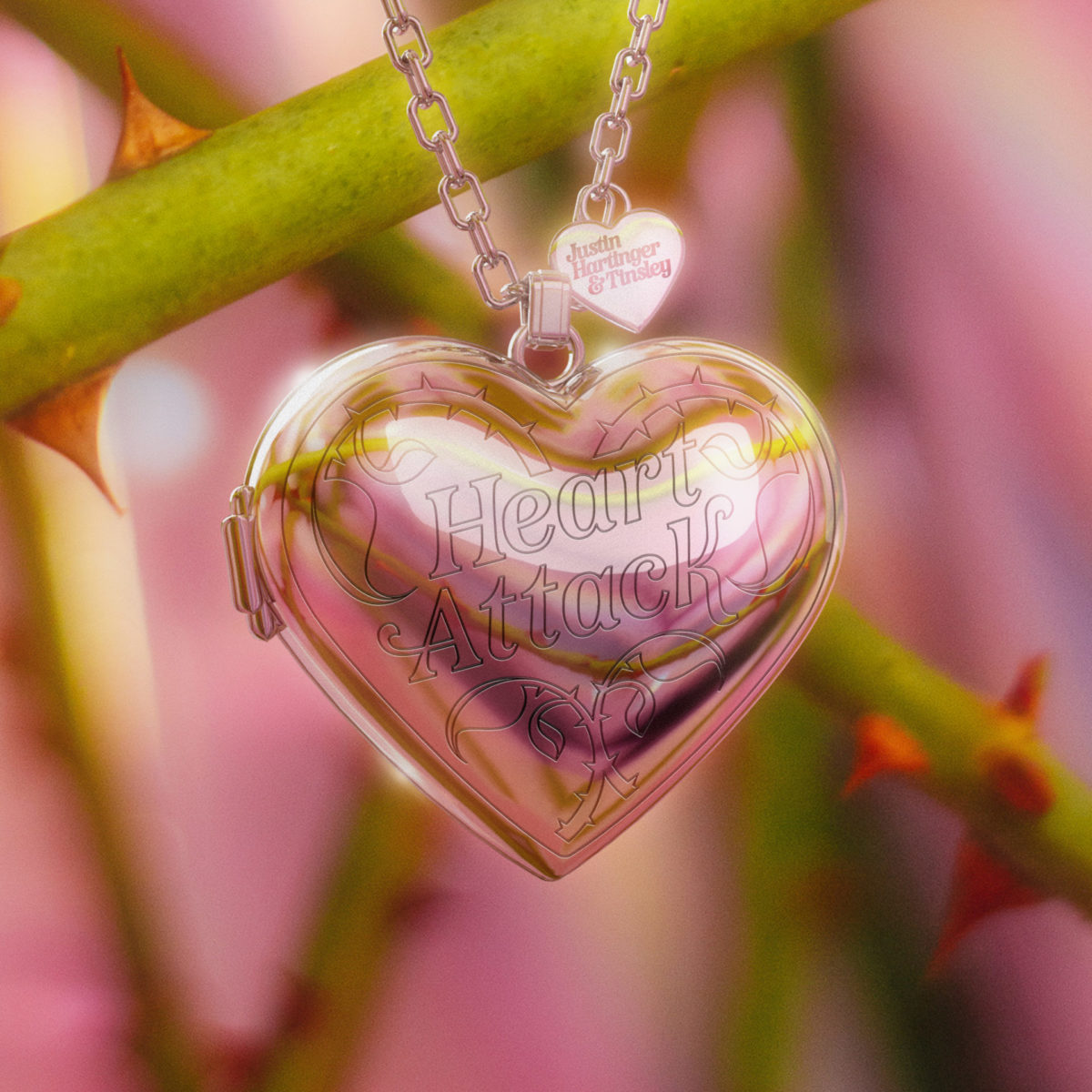 A heart pendant hanging on rose stems with a pink background