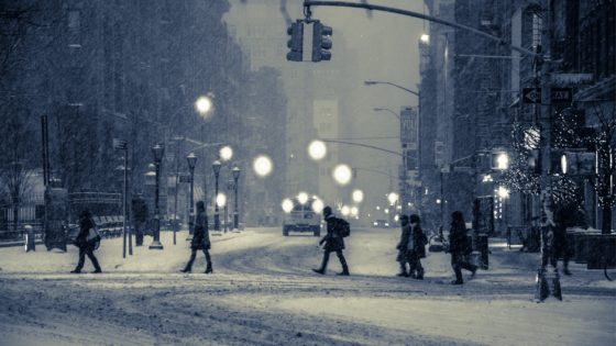 People crossing the street in snow