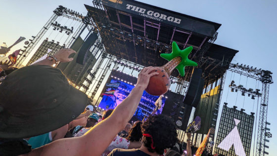 The main stage at Above & Beyond Weekender at The Gorge a girl with a blow-up palm tree