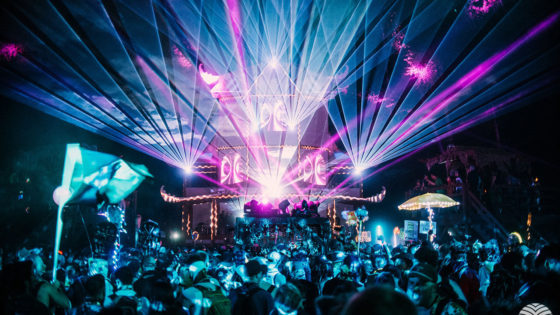 Image of Shambhala stage at night with purple lasers and blue lights.