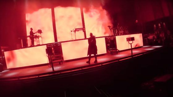 YouTube screen grab of RUFUS DU SOL performing On My Knees live at the Gorge Amphitheater with red and yellow stage lights.