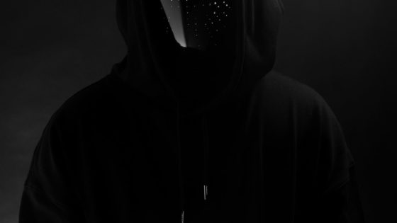 Picture of Deathpact wearing LED mask and black hoodie with dark background