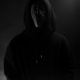 Picture of Deathpact wearing LED mask and black hoodie with dark background