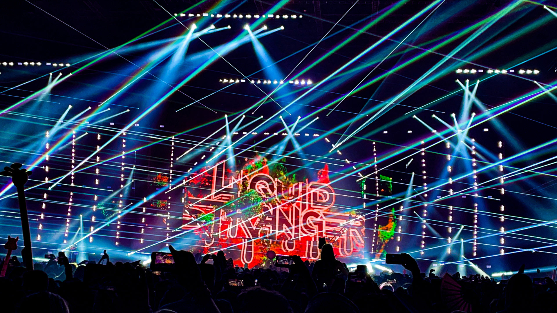 Excision's Thunderdome 2023 main stage with blue, green, and white lasers shining during Liquid Stranger's set