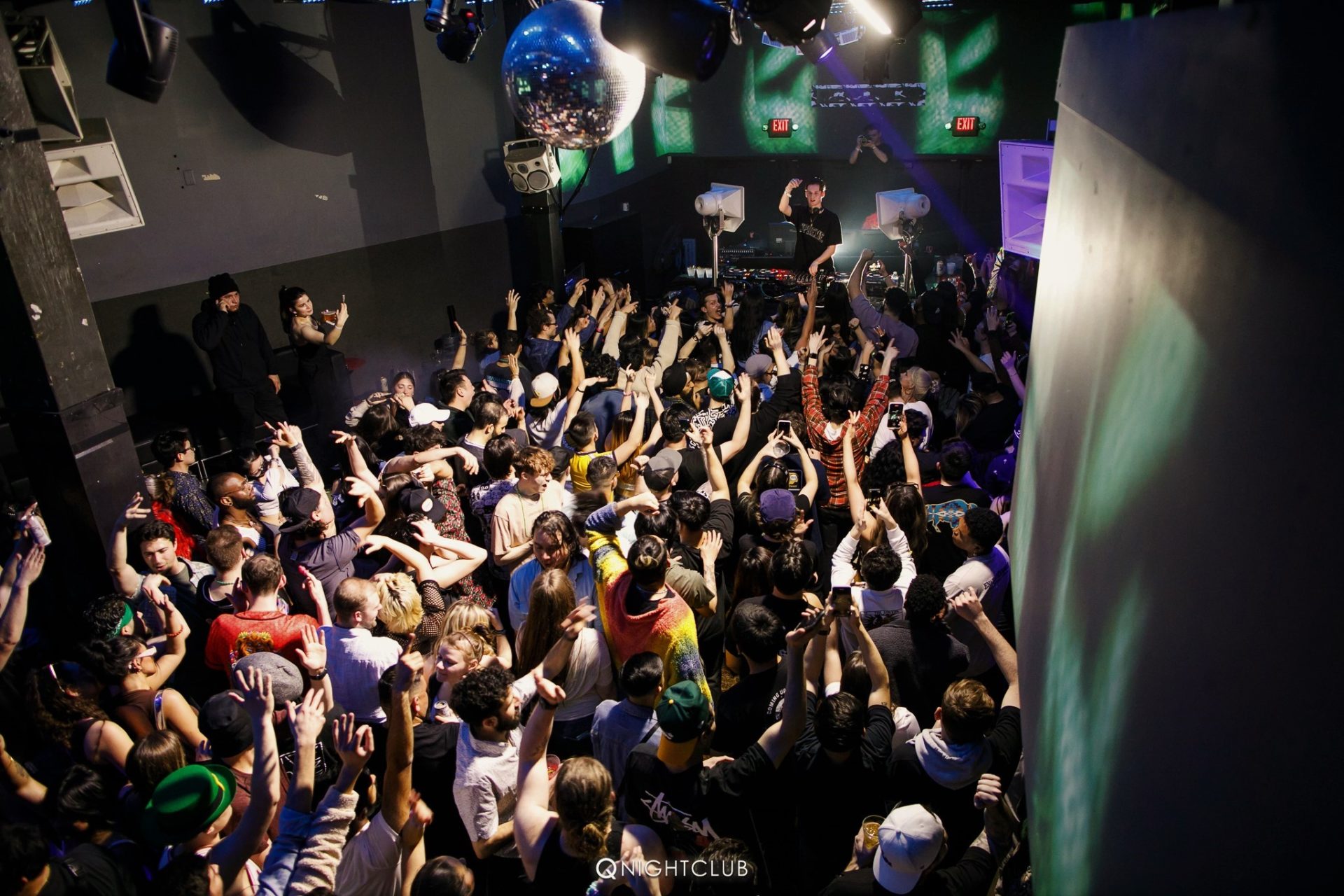 Behind crowd photo of Q Nightclub while Mau P is performing