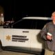 Emergency response officer standing in front of white SUV reporting on the shooting at Beyond Wonderland at The Gorge