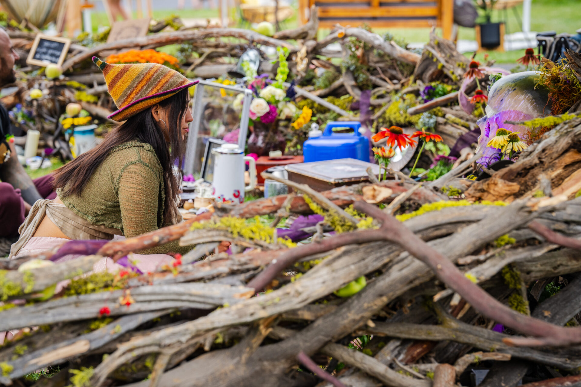 A woman sitting in an art instillation at cascade equinox festival