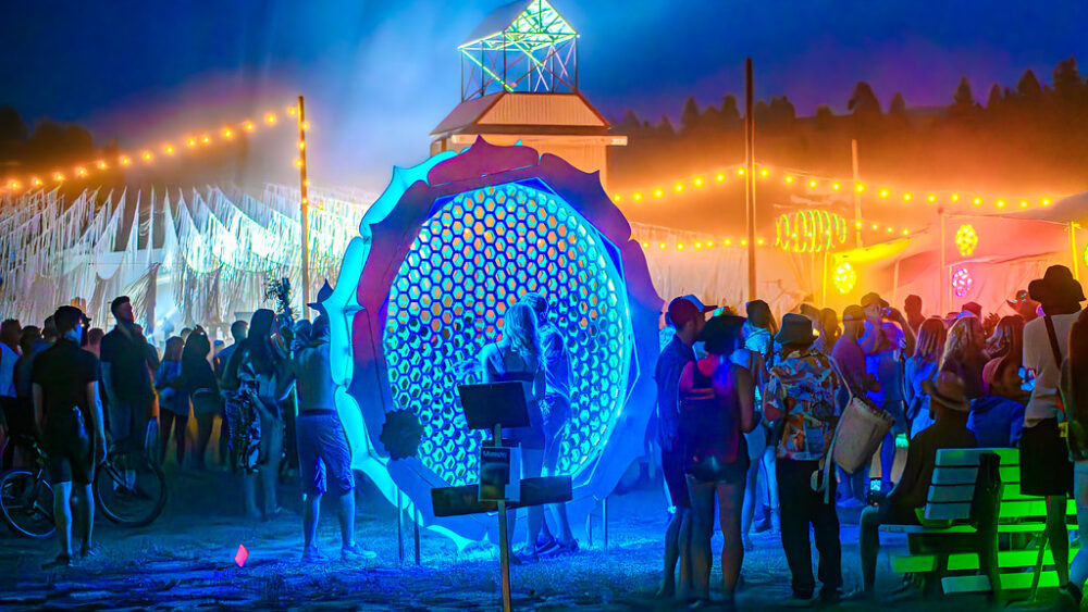 Festival attendees gather near an art installation in 2023