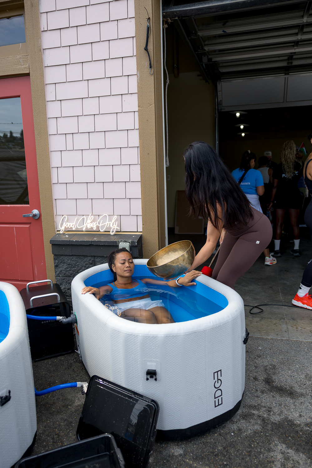 A woman relaxing in a cold plunge tub provided by Space B.A.R. Wellness