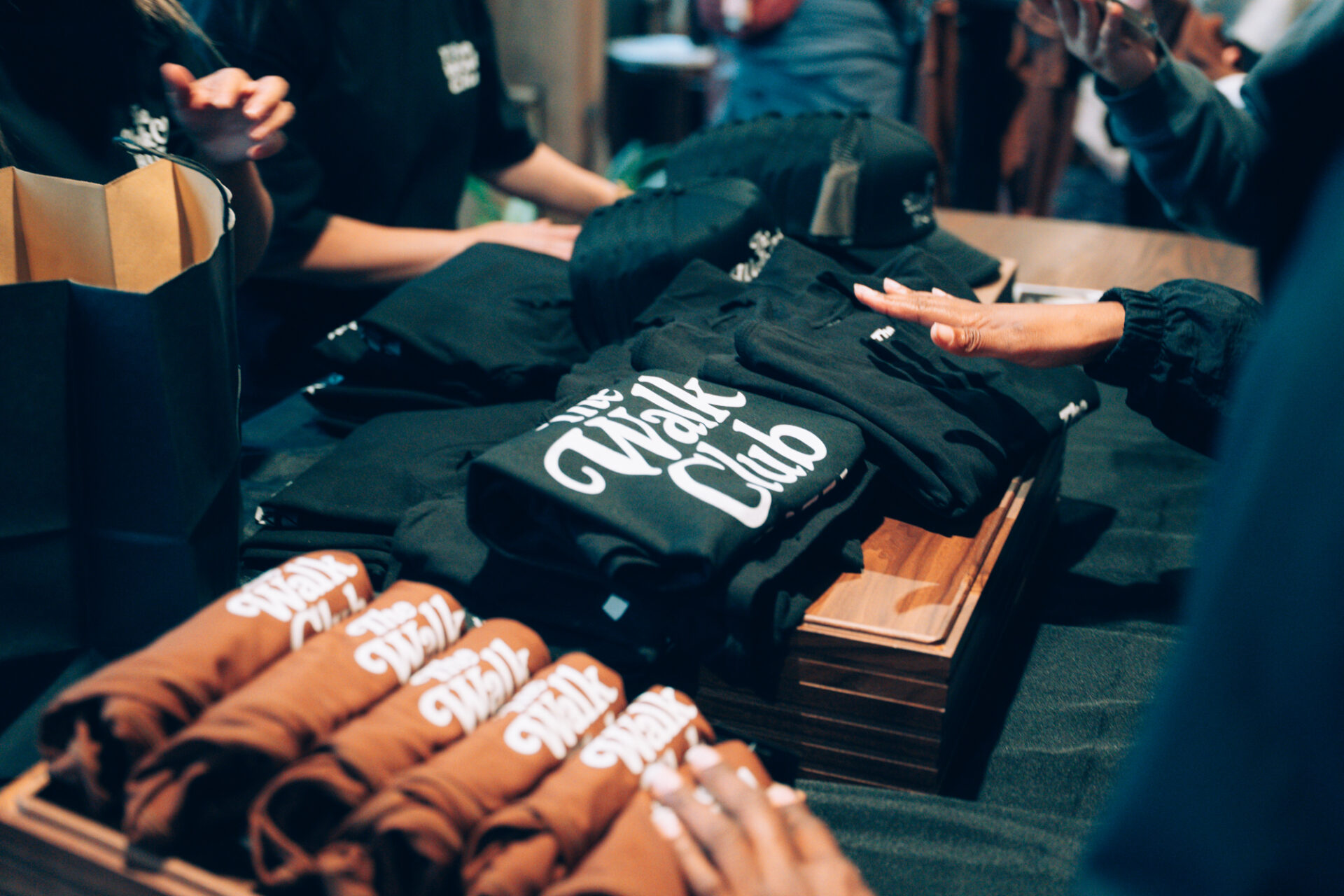 The Walk Club merchandise spread across a table