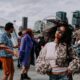 woman in sunglasses dancing to electronic music in front of the Seattle ferris wheel